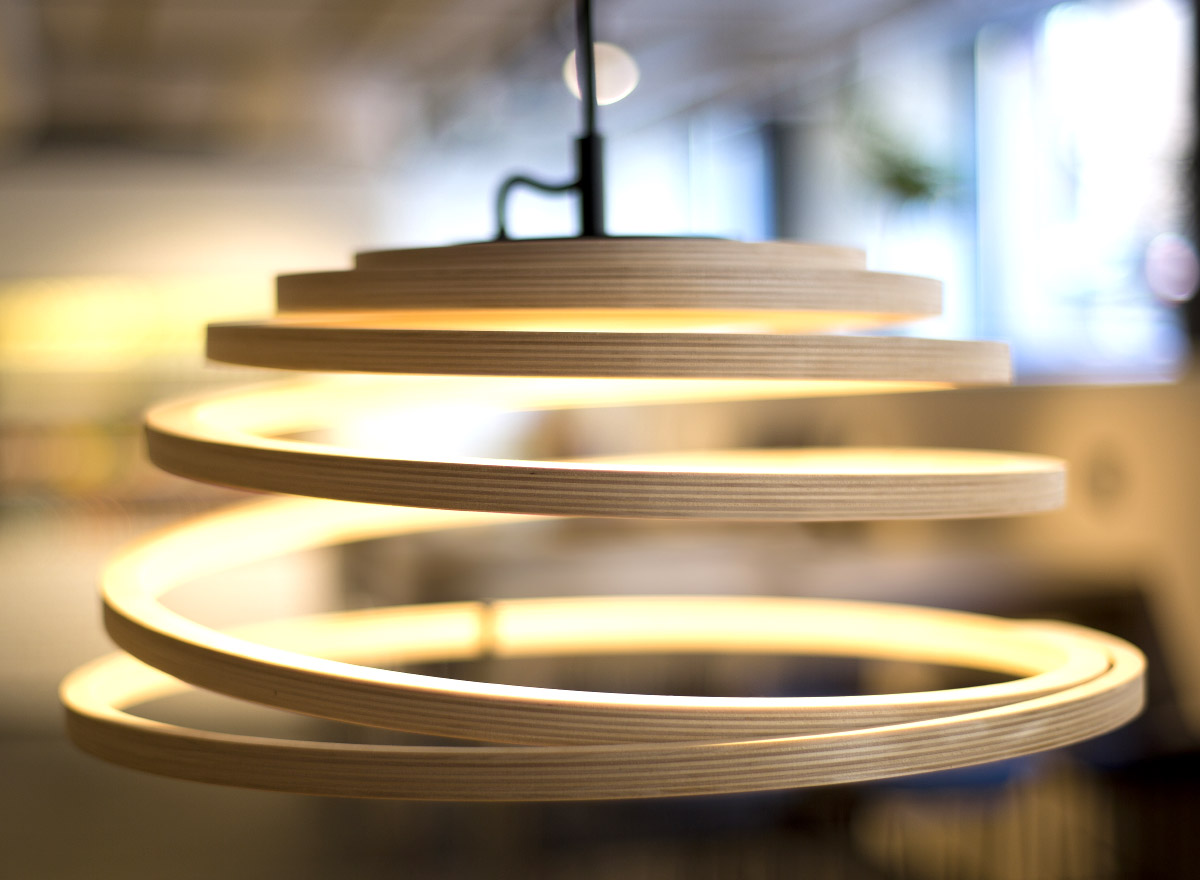 A close-up of the Aspiro pendant lamp with a black cable.