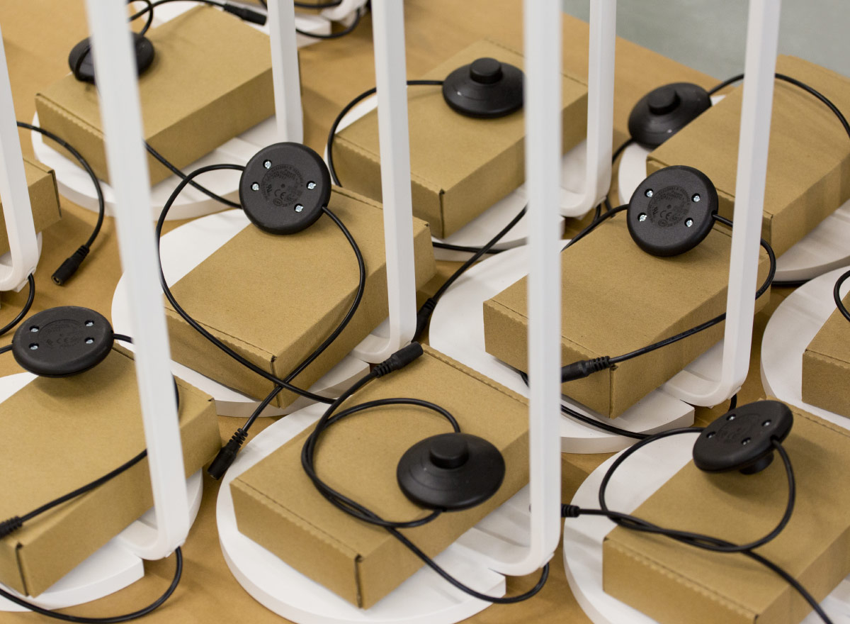 A collection of lampstands with packed cables.