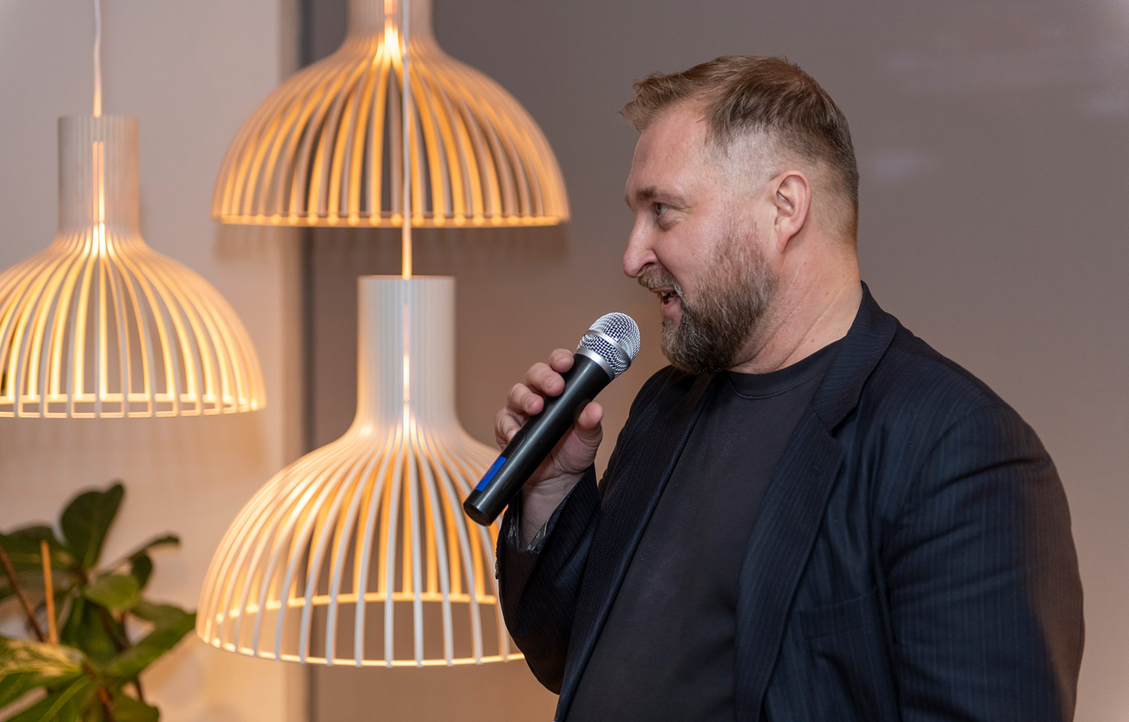 A man talking with a microphone on his hand.