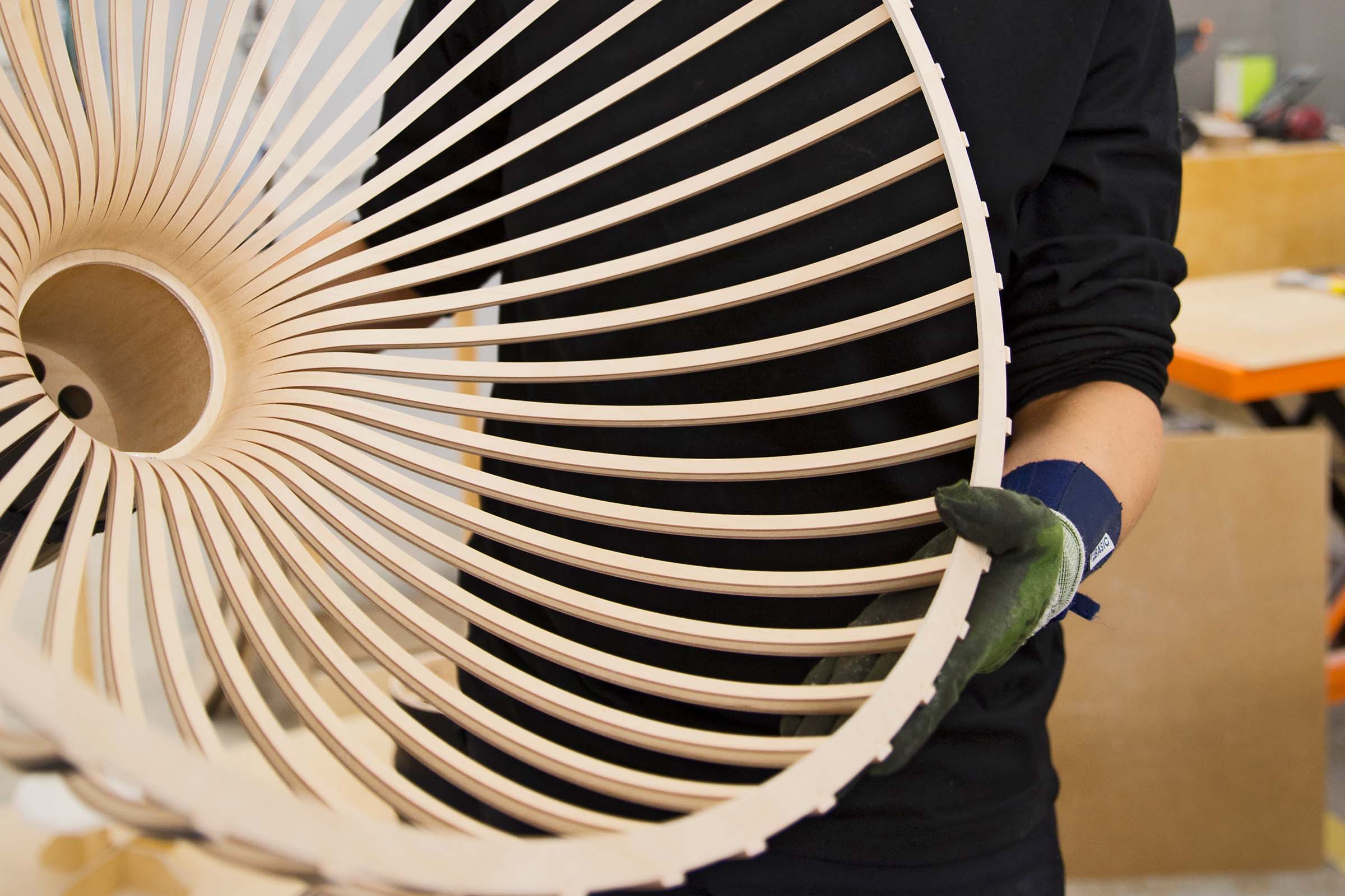 A person holding the Victo pendant lamp, showing its inside.