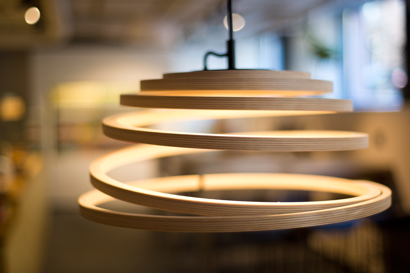 A close-up of the Aspiro pendant lamp with a black cord.