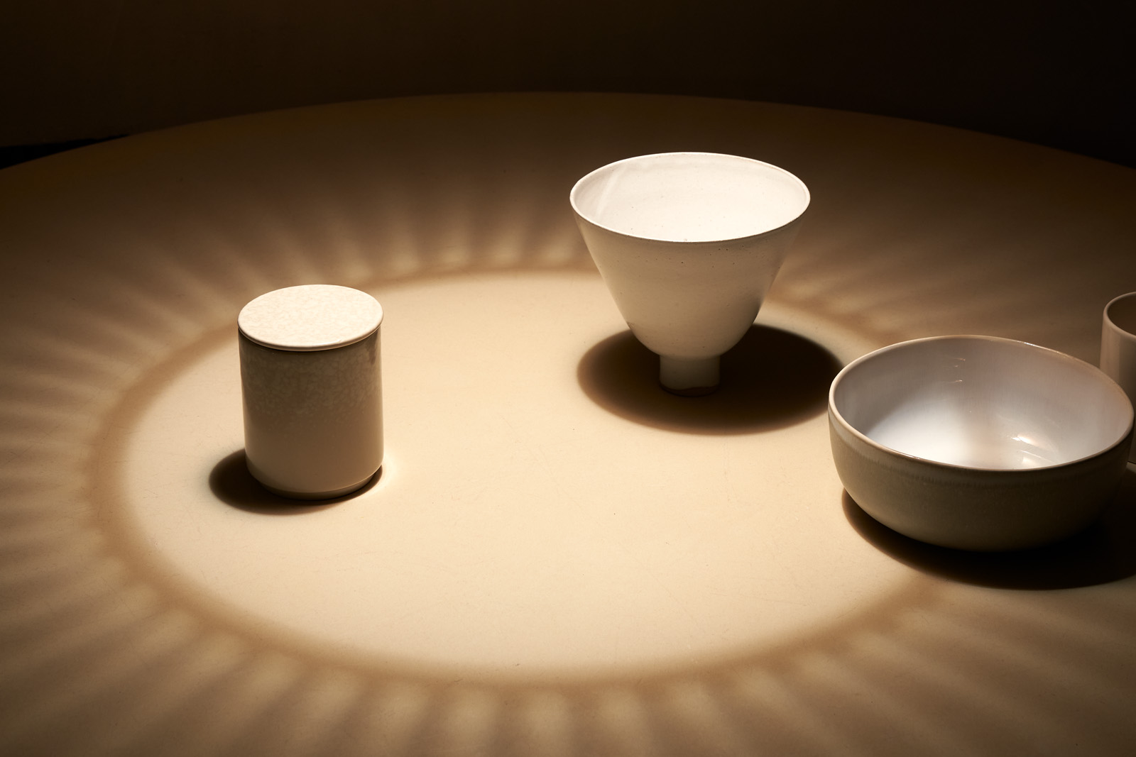 The Secto pendant lamp above a table with dishes.