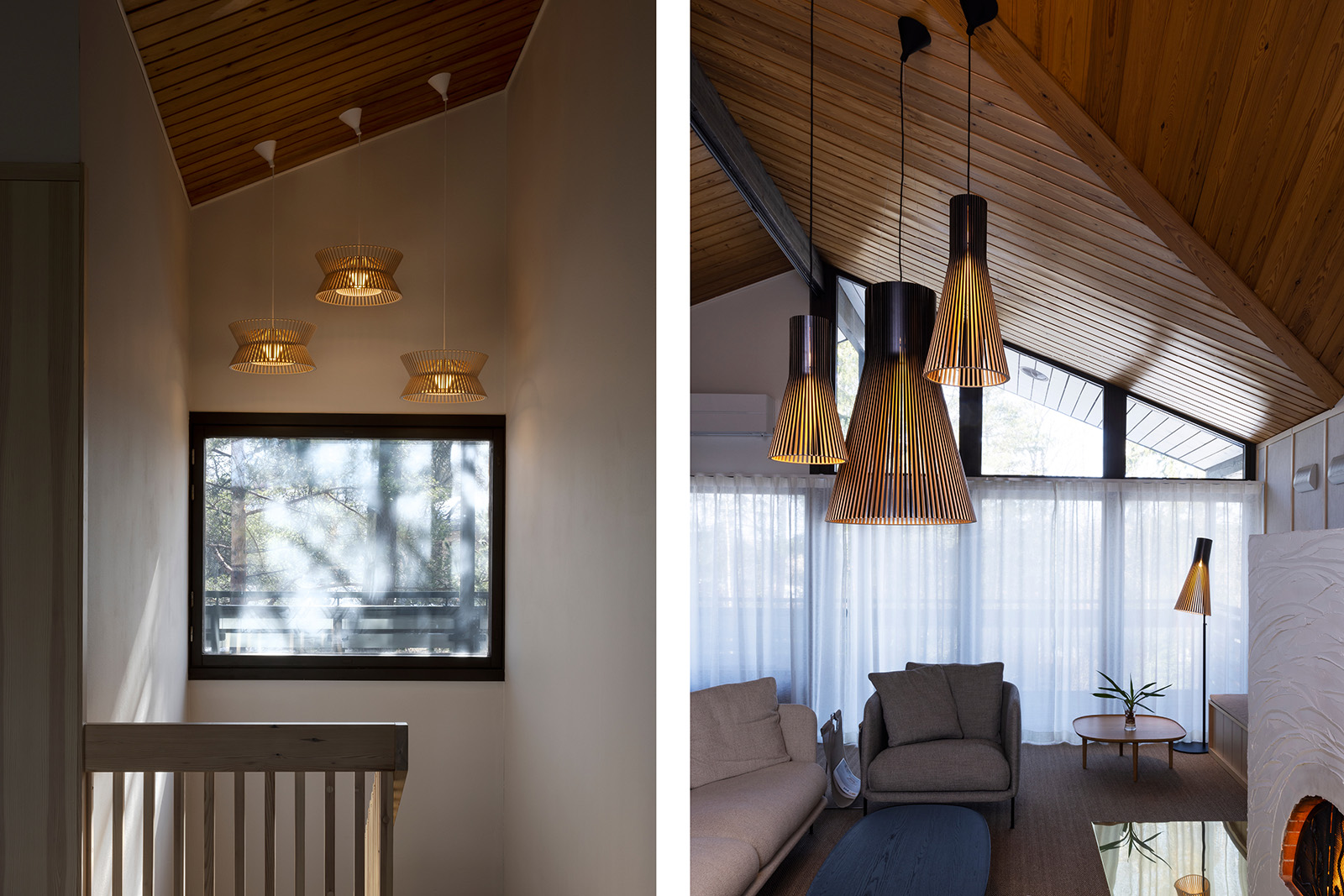 A large hall with sofas, lamps and a fireplace. Three pendants above a stairway.