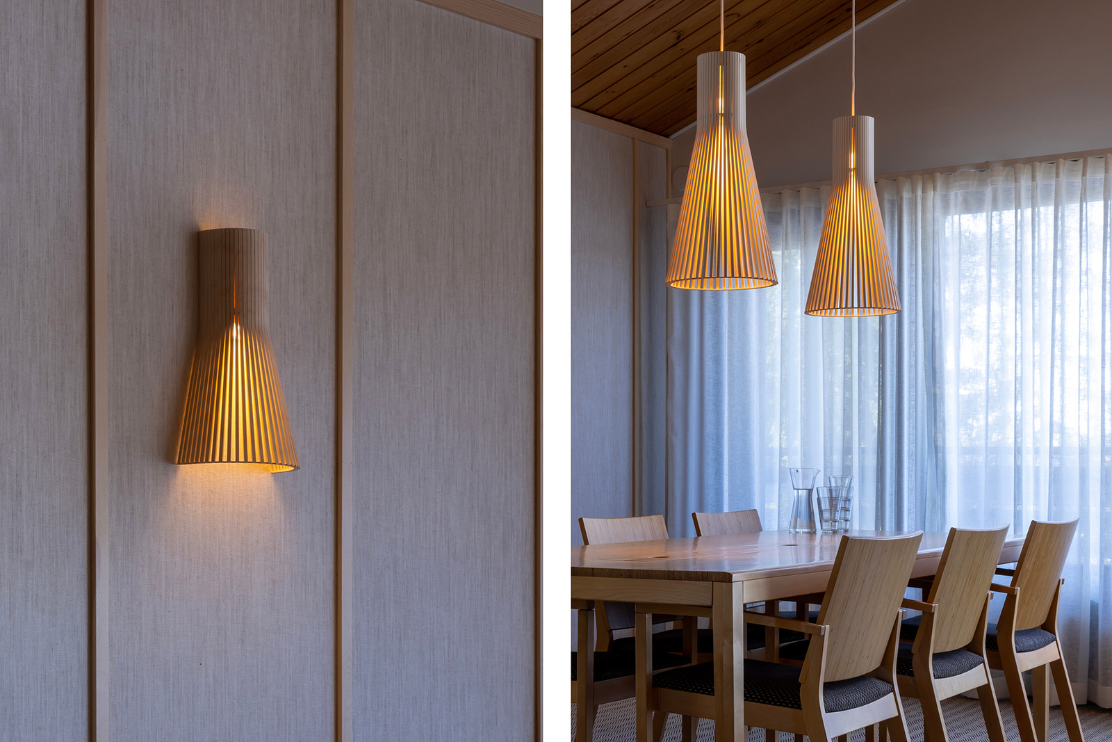 A close-up of a wall lamp. Two pendants above a conference table.