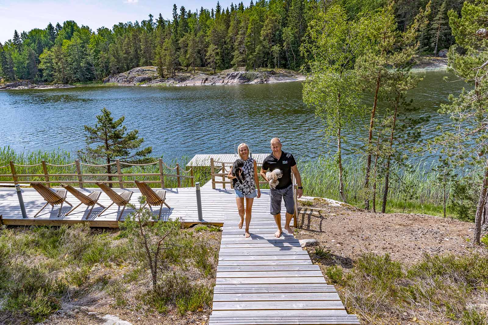 A woman and a man walking up the stairs from a pier.